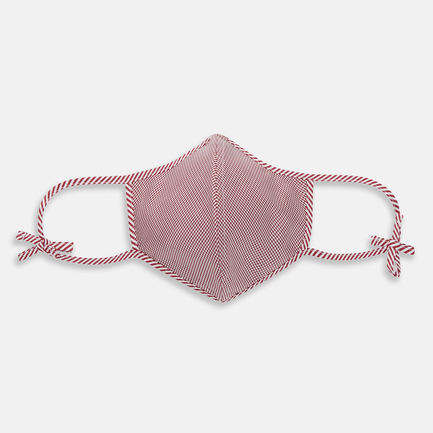 View 1 of product The Turnbull & Asser Burgundy Check Commuter Mask comes with 3 Viroformula™ filters. It features a check pattern, adjustable ear straps, and is displayed on a plain white background.