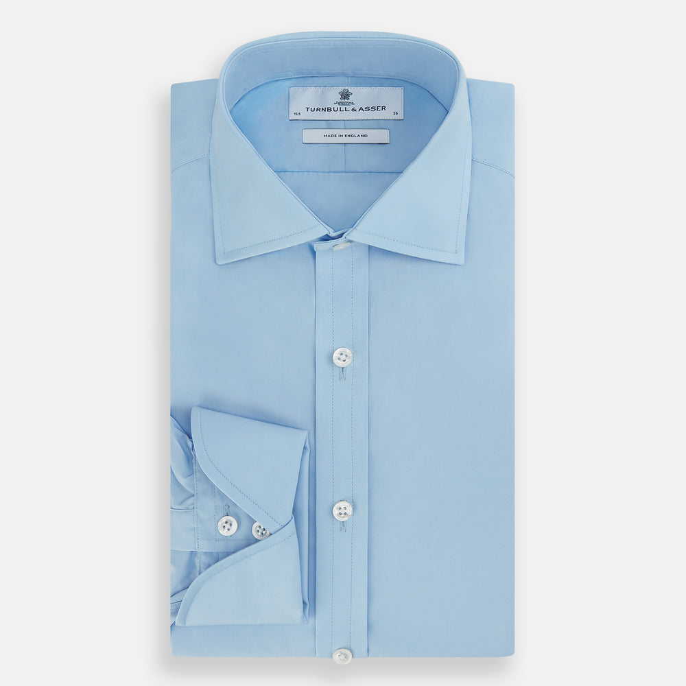 The Turnbull & Asser Dr. No Blue Cotton Shirt with cocktail cuffs, inspired by James Bond, features a classic collar and white buttons, displayed on a plain white background.