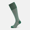 View 1 of product The Ivory/green Houndstooth Long Sock by Turnbull & Asser features a houndstooth pattern on the lower half with a solid green upper band, heel, and toe, shown against a white background.