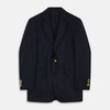View 1 of product The Turnbull & Asser Navy Plain Wool Single Breasted Blazer, with brass front and cuff buttons and an asymmetric pocket design, is shown laid flat on a white background.