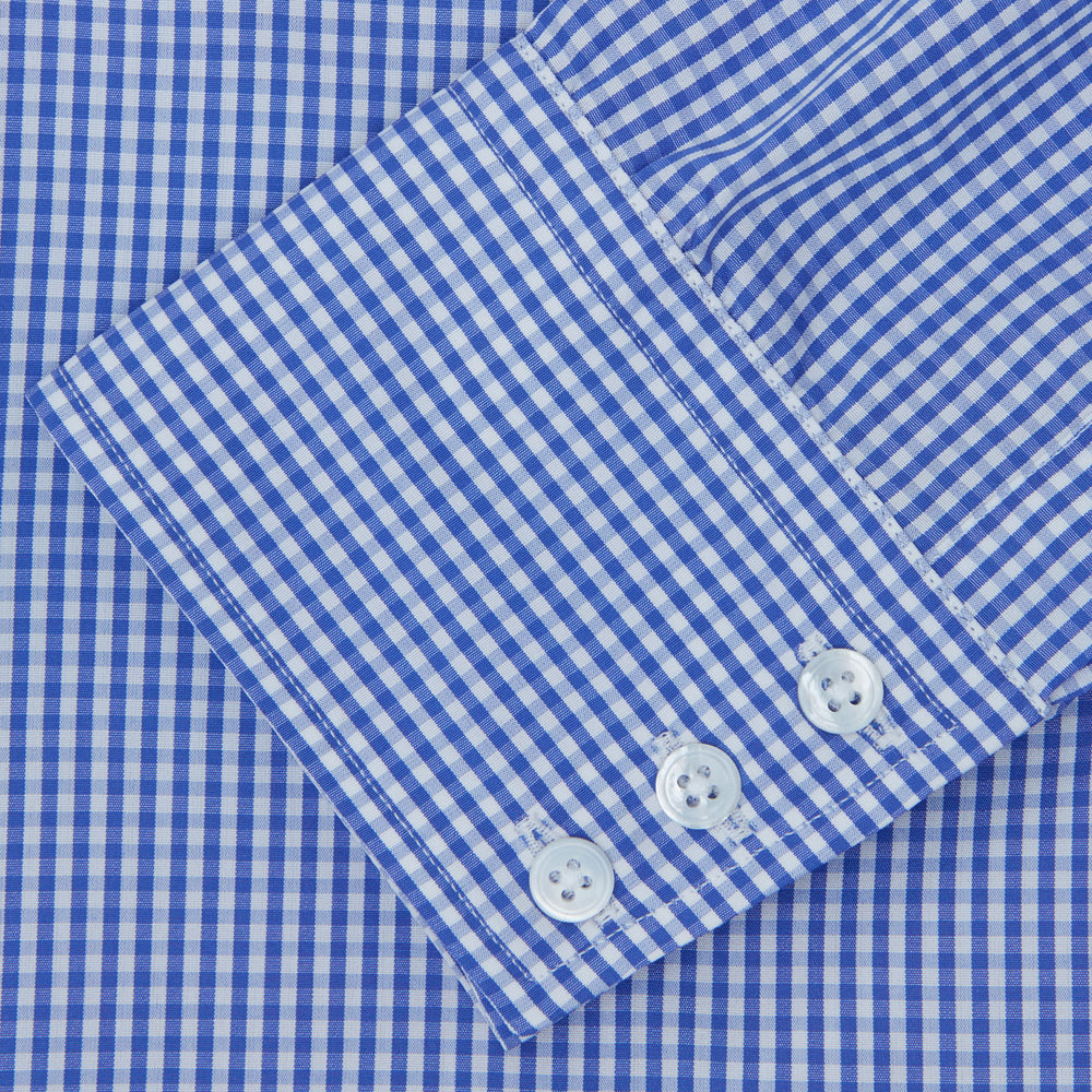 The Turnbull & Asser Mid-Blue Gingham Check Shirt features a T&A collar and 3-button cuffs, crafted from soft cotton and displayed against a plain white background.