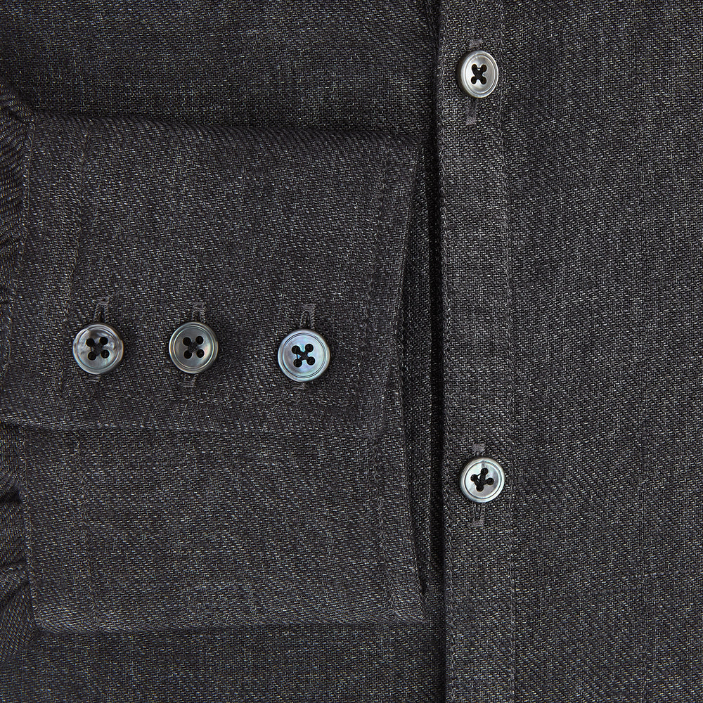 The Ash Linen Windsor Shirt by Turnbull & Asser is a long-sleeve, button-up black shirt with a Windsor collar and cuffs, reflecting British craftsmanship, shown on a plain white background.
