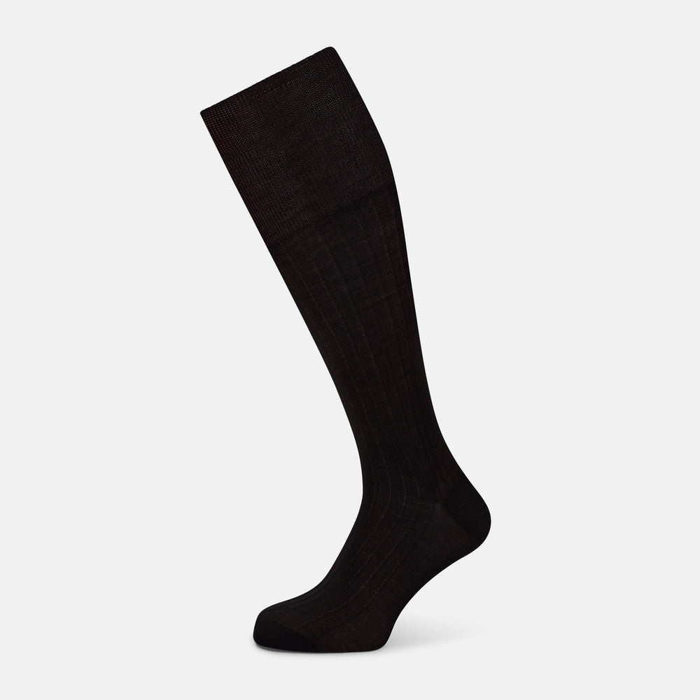 A single Dark Chocolate Long Sock by Turnbull & Asser is displayed against a plain white background, showcasing its knee-high length and foot shape.
