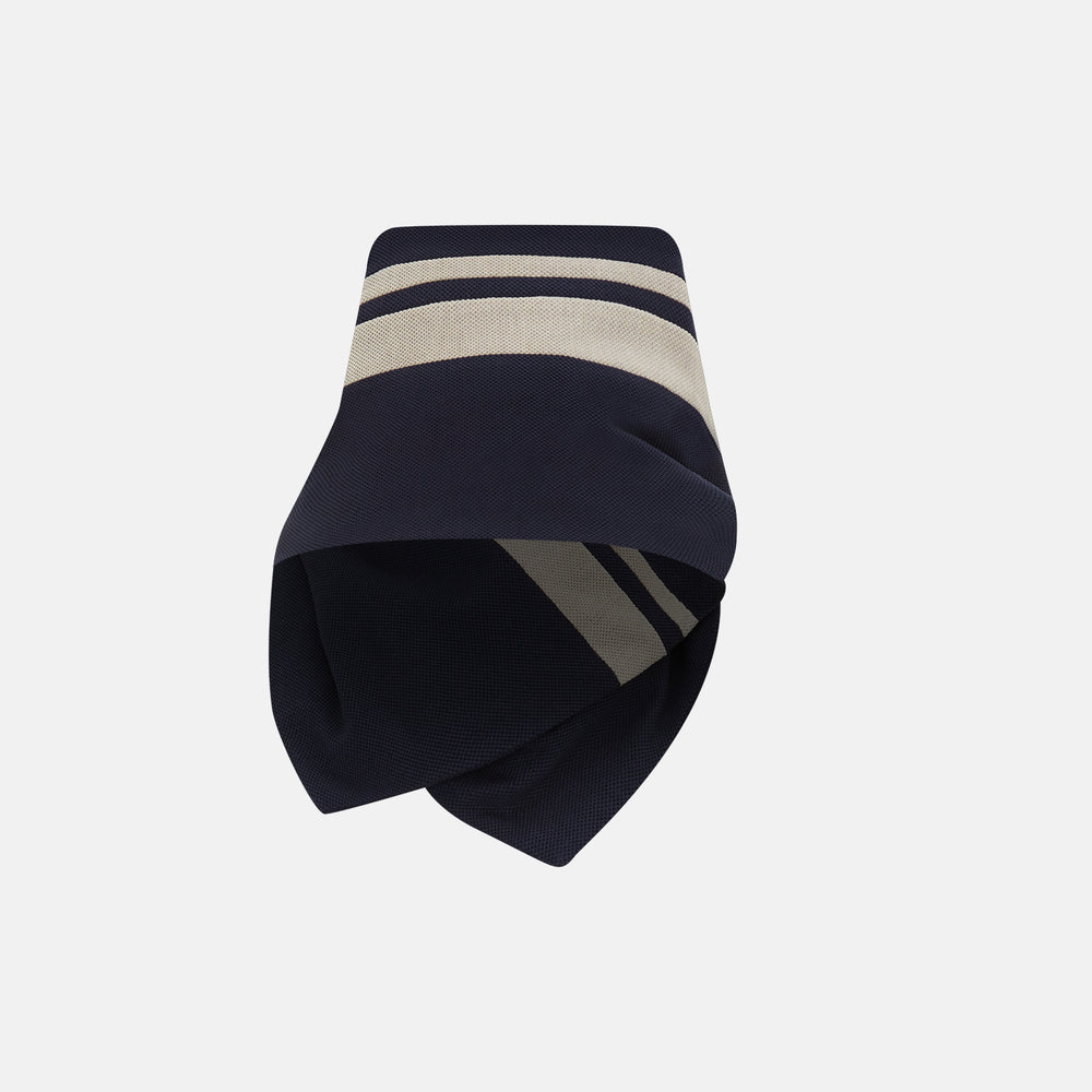 The Navy and Sand Stripe Neck Warmer by Turnbull & Asser features two beige diagonal stripes and a black button, draped in a V shape on a white background—an elegant formal accessory for any occasion.
