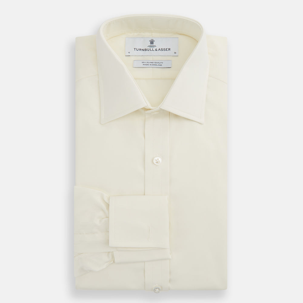 The Turnbull & Asser Tomorrow Never Dies Cream Cotton Hamburg Shirt, as seen on James Bond, features a long sleeve, button-down front, and collar. It's laid flat on a white background.