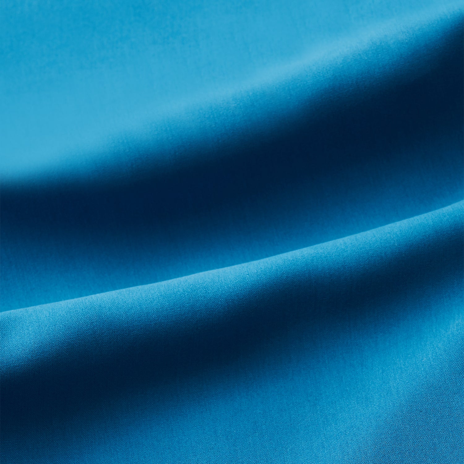 View 2 of product The Turnbull & Asser Blue Silk Hyde Pyjama Set features a modern fit with a long-sleeve button-up top, three pockets, white trim, and elastic-waist pants, all shown on a white background.