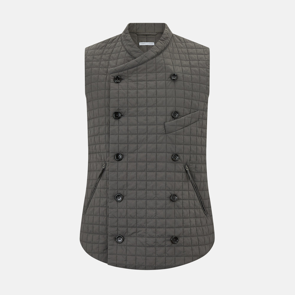 The Turnbull & Asser Shadow Grey Double-Breasted Quilted Gilet features a sleeveless design, asymmetrical collar, side zip pockets, slanted chest pocket, grid pattern, and modern black buttons—perfect for layered dressing.