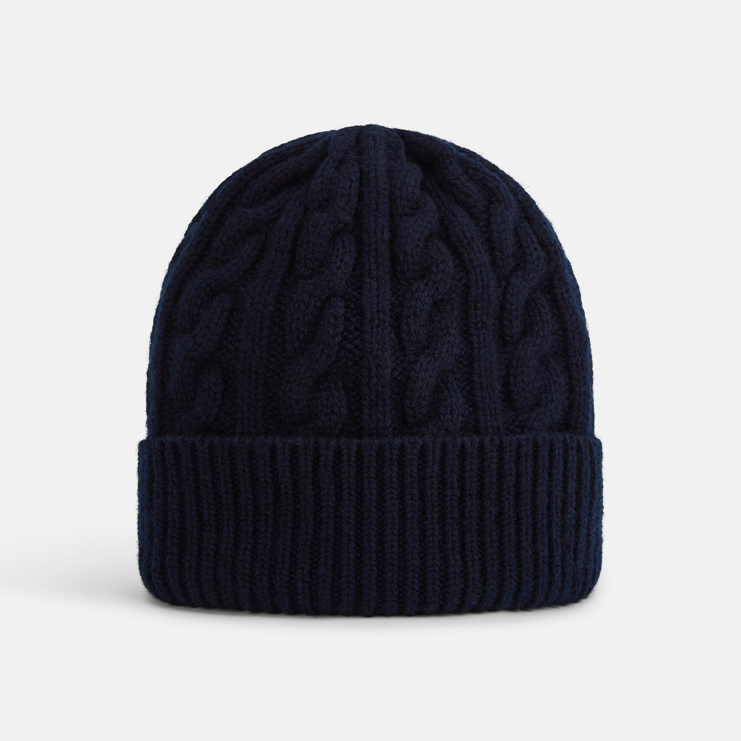 View 1 of product The Turnbull & Asser Midnight Blue Cable Knit Cashmere Beanie features a ribbed folded brim and chunky cable pattern, expertly knitted in England, and shown against a plain white background.