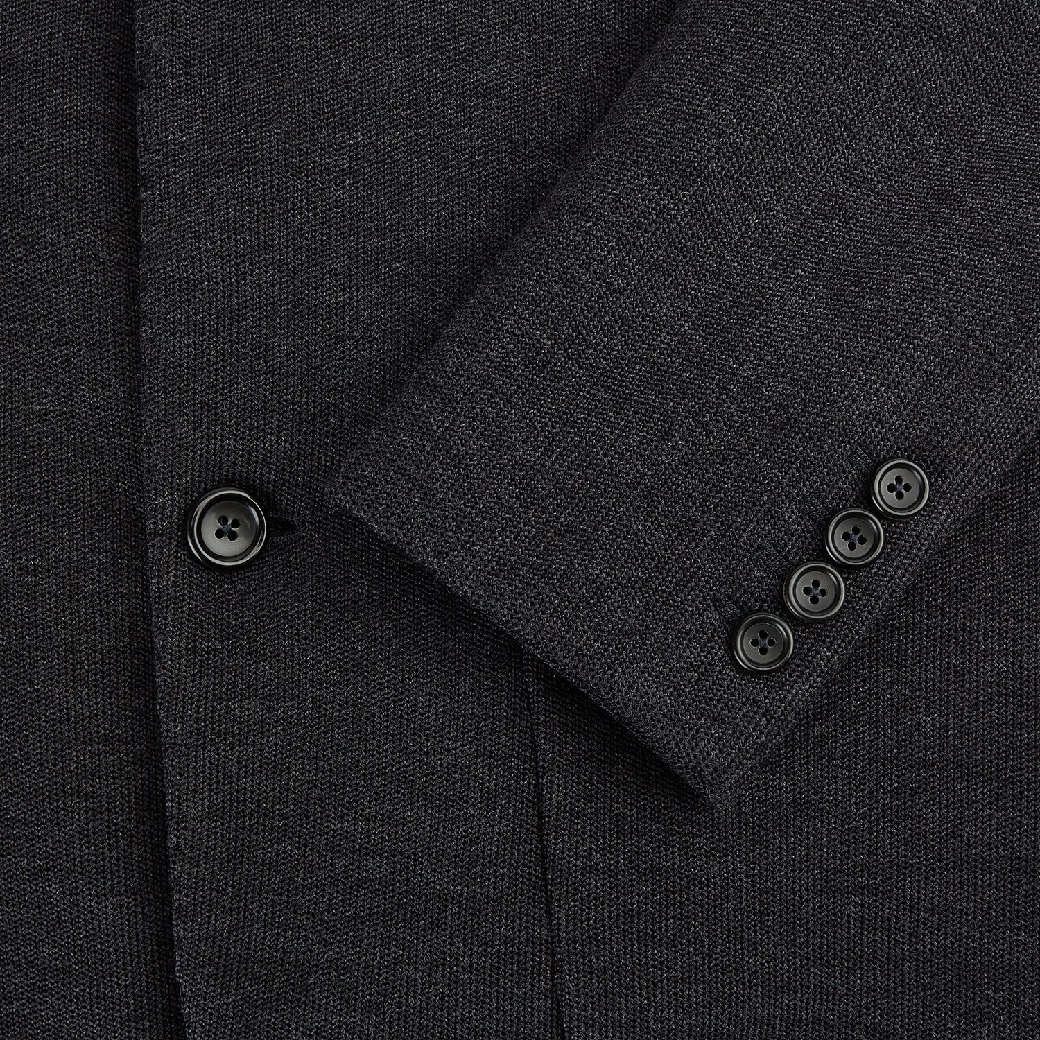 Image 4 of product The Turnbull & Asser Charcoal Knitted Oxford Blazer features a notched lapel, two-button closure, and three front pockets, blending modern elegance with British heritage against a plain white background.