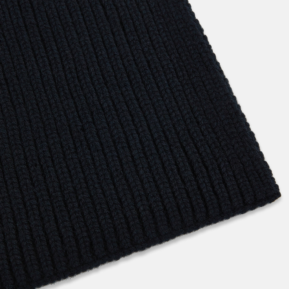 The Navy Rib-Knit Cashmere Scarf by Turnbull & Asser is neatly folded and looped in a simple knot against a white background, highlighting its refined luxury appeal.