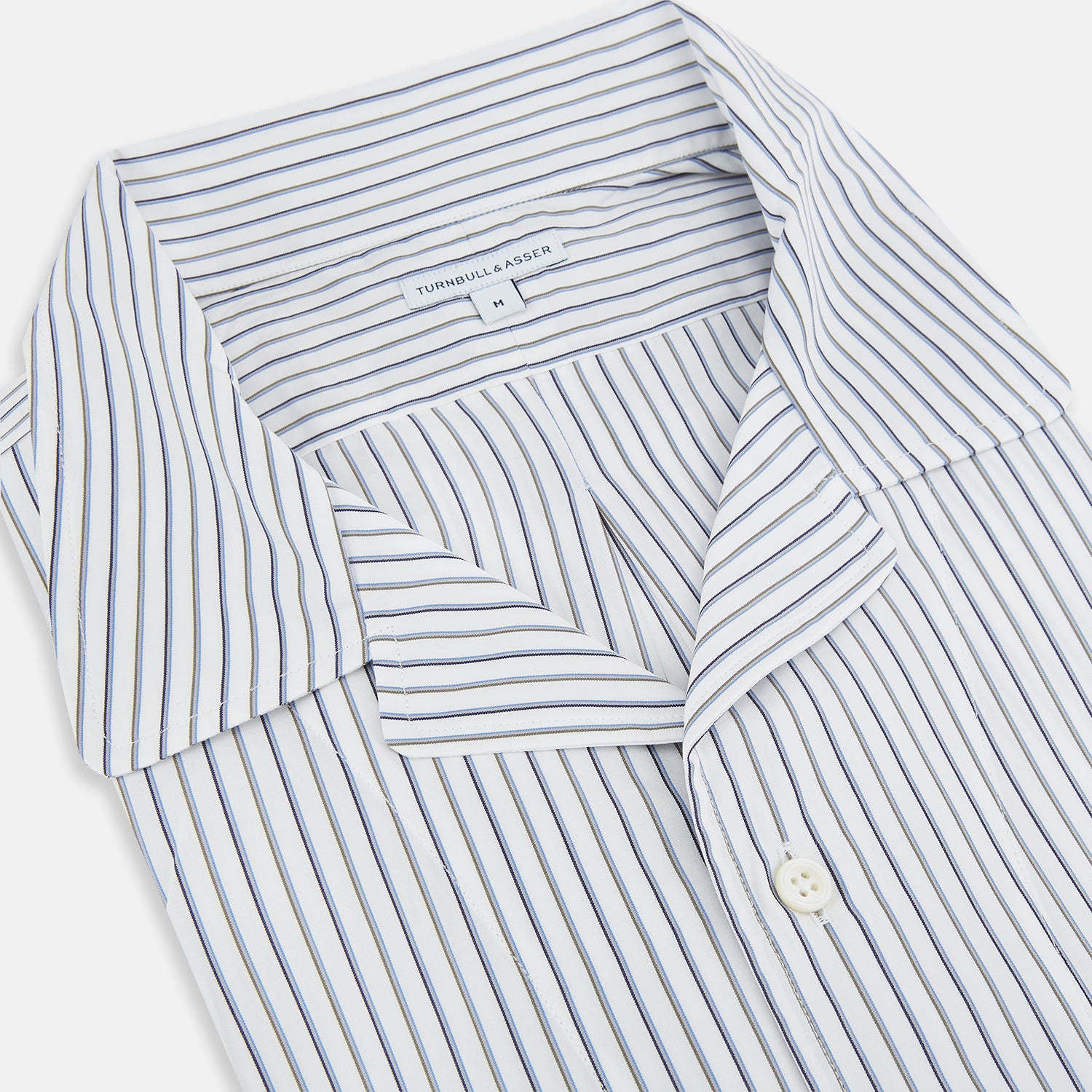 View 2 of product The Brown Multi Stripe Quarzo Nightshirt by Turnbull & Asser is a long-sleeve, knee-length Italian cotton nightshirt with brown and blue stripes, a collar, button placket, chest pocket, and cuffs. The dress is laid flat on a white background.