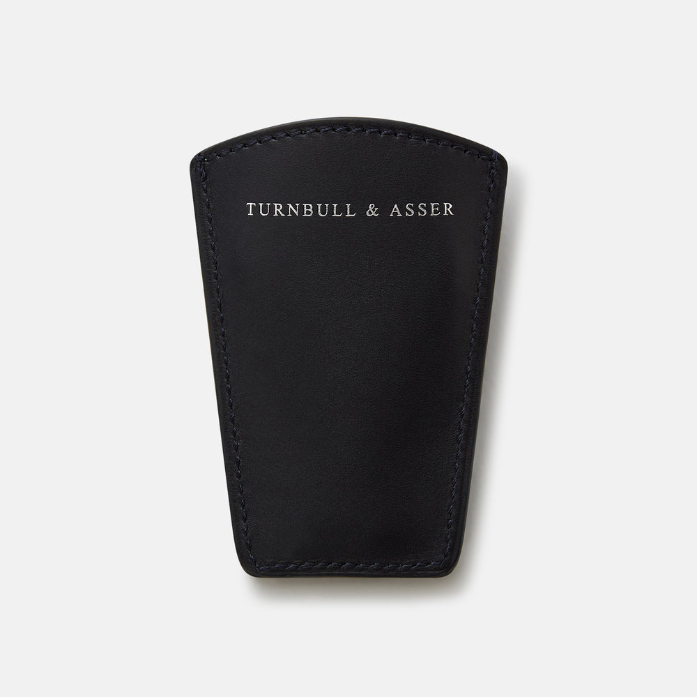 The Turnbull & Asser Navy Travel Shoe Horn features a wide, smooth silver blade and a navy leather-wrapped handle, shown against a plain white background.