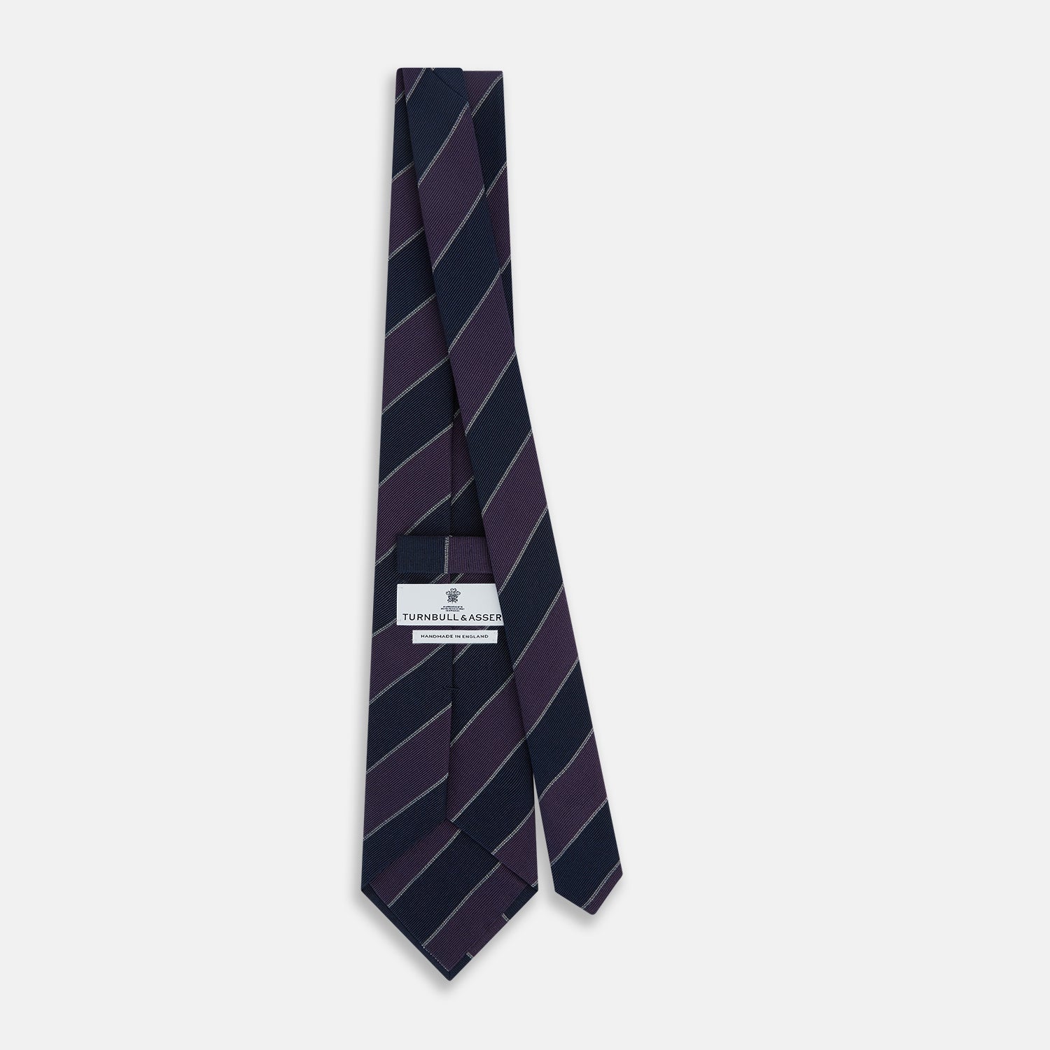 View 4 of product The Turnbull & Asser Purple And Navy Block Stripe Silk Blend Tie features dark navy and deep purple stripes with thin light gray lines, making it a refined formal accessory. Displayed on a white background.
