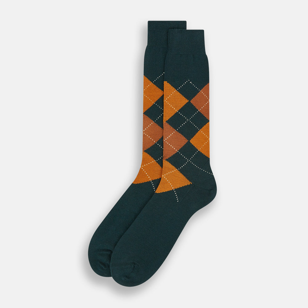 The Forest Green Wool Check Mid-Length Socks by Turnbull & Asser feature a dark green base with orange and brown argyle checks and white dotted lines, shown against a plain white background.