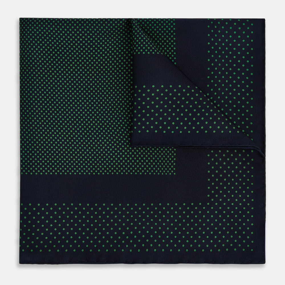 The Turnbull & Asser Navy and Green Dot Silk Pocket Square features dense green polka dots on navy silk, a solid navy border, and a band of spaced green dots—expertly handmade with precise finishing for an elegant look.
