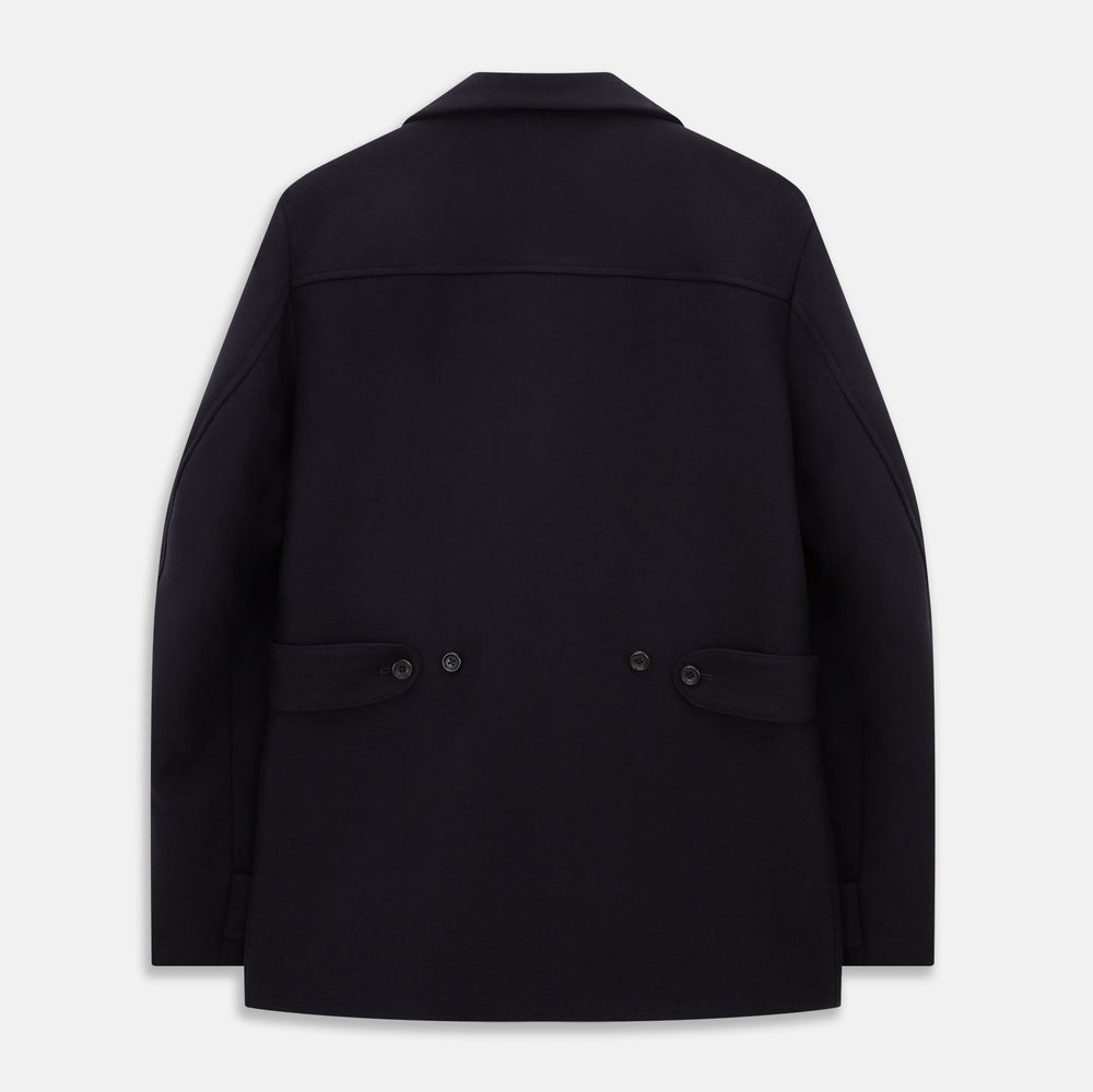 The Turnbull & Asser Navy Wellington Double-Breasted Caban Coat features wide lapels, six front buttons, a chest pocket, and two side pockets with buttoned flaps—ideal for polished formal wear.