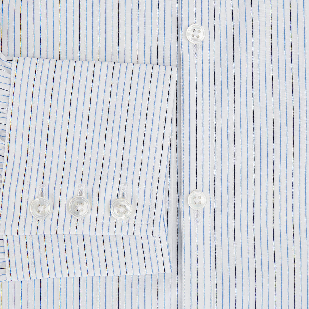 The Turnbull & Asser Pale Blue and Navy Pinstripe Westminster Shirt features long sleeves, a classic collar, and buttoned cuffs, highlighting British craftsmanship. The shirt is laid flat on a white background.