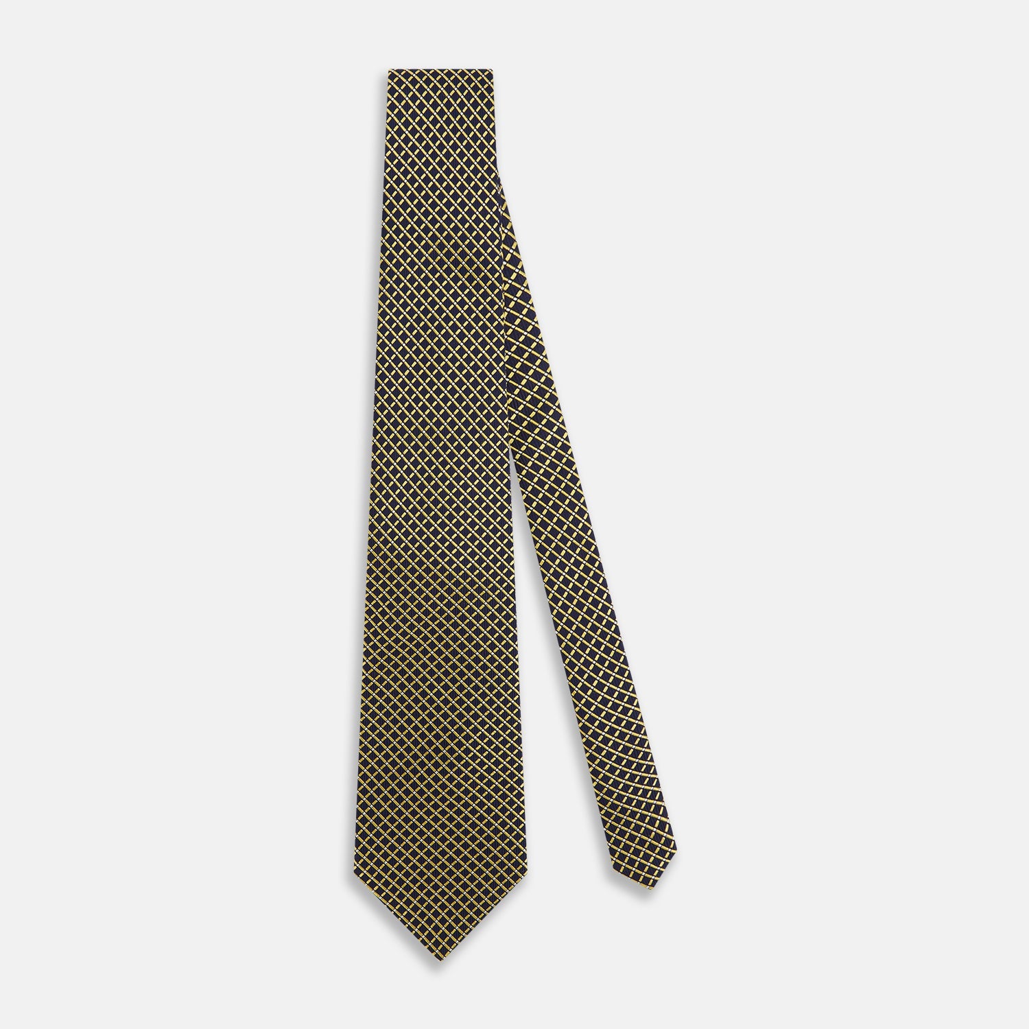 View 2 of product The Turnbull & Asser Yellow and Navy Diamond Silk Tie, with a refined yellow and light blue grid pattern, is elegantly rolled up on a plain white background.