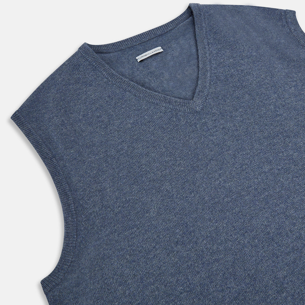 The Avio Blue Cashmere V-neck Vest by Turnbull & Asser is a sleeveless knitwear piece with ribbed hem and armholes, shown against a plain white background.