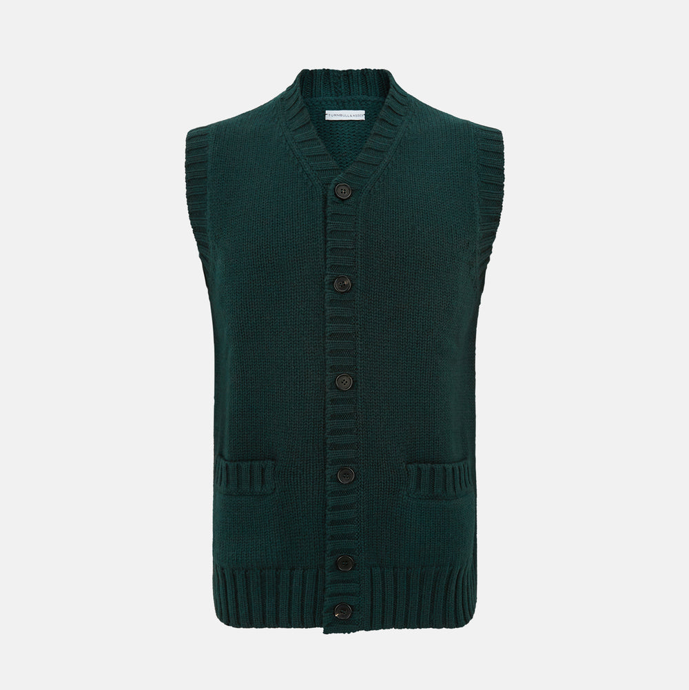 Turnbull & Asser’s Forest Green Merino V-Neck Sleeveless Cardigan features ribbed trim, button-down front, and two front pockets—ideal for the discerning gentleman. Shown on a plain white background.