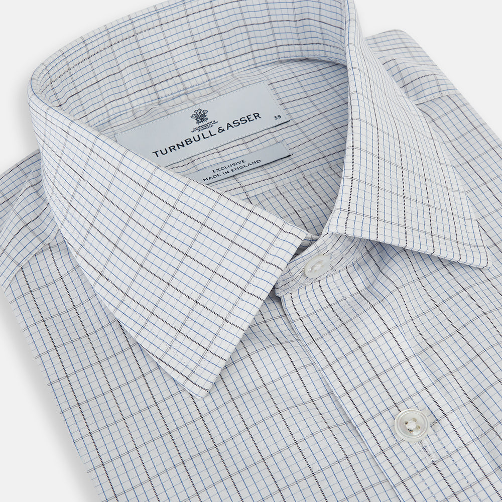The Turnbull & Asser Navy and Blue Multi Grid Check Mayfair Shirt is a long-sleeve, button-up Italian cotton shirt with a collar and cuffs, featuring a blue grid check pattern, shown against a plain white background.