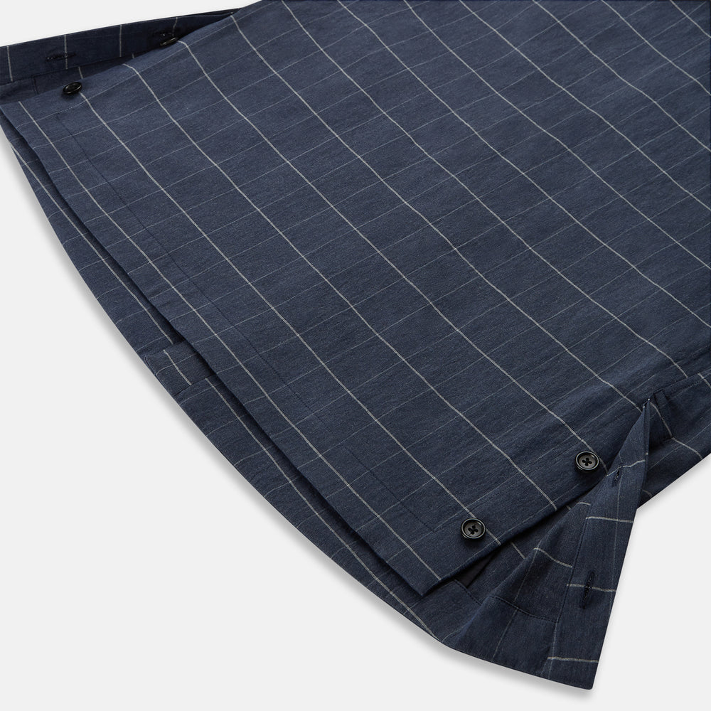 The Turnbull & Asser Royal Blue Check Hampstead Overshirt features a white windowpane pattern, long sleeves, two front pockets, and a chest pocket, displayed on a plain white background for an elegant classic look.