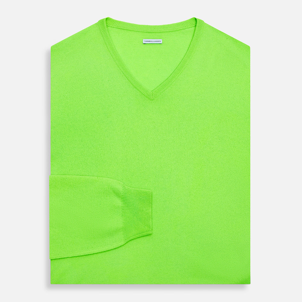 The Turnbull & Asser Bright Green Cashmere V-Neck Jumper, a long-sleeved knitwear piece, is showcased against a plain light gray background.