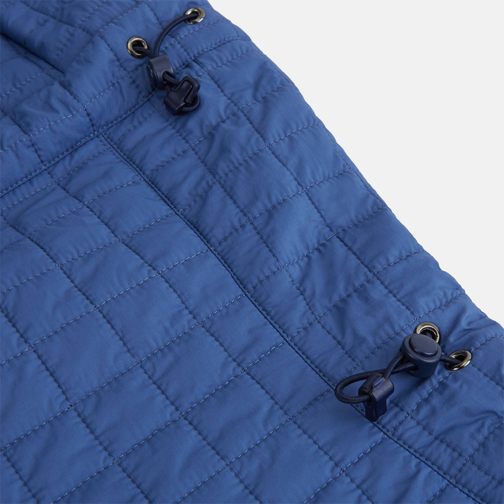 The Turnbull & Asser Azzurro Quilted Hood with Neck Warmer features a grid-stitched pattern, button closure, and overlapping front for added style. It draws inspiration from classic quilted jackets and is shown on a plain white background.