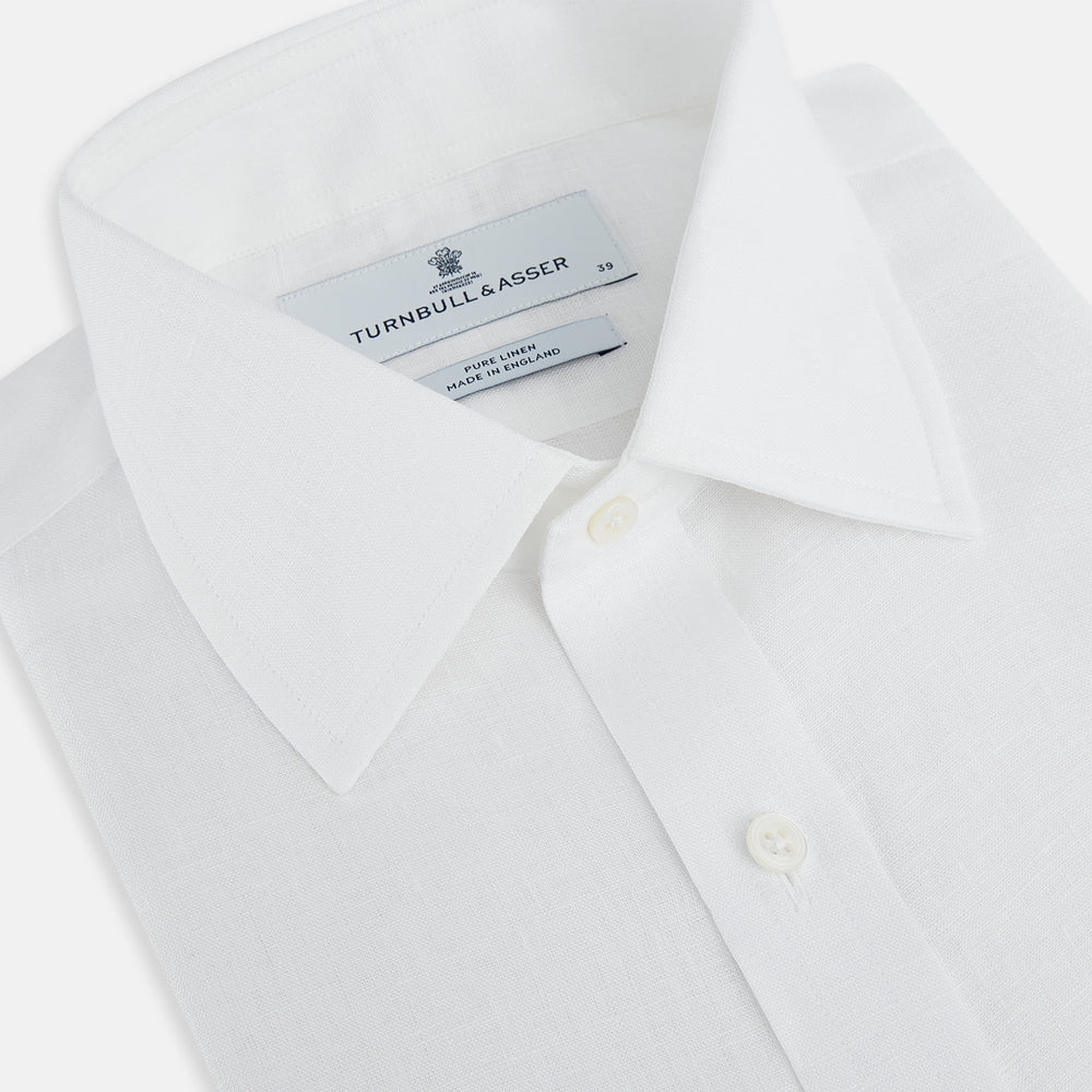 The Turnbull & Asser White Linen Mayfair Shirt features long sleeves and a classic collar, shown on a flat white background.