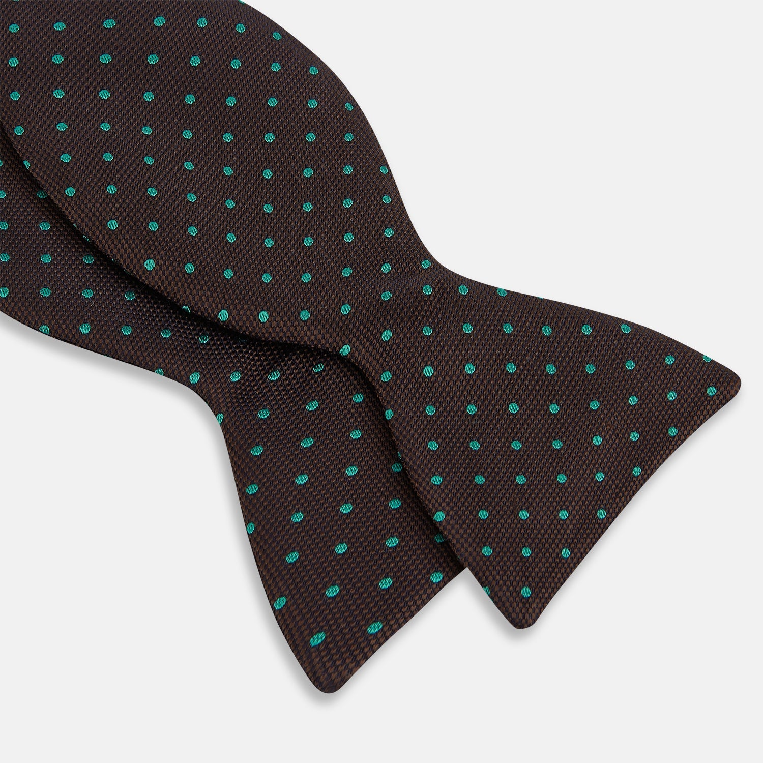 View 2 of product The Blue and Brown Micro Dot Silk Bow Tie by Turnbull & Asser features subtle blue micro dots on brown silk, photographed on a plain white background—a sophisticated men's accessory perfect for formal events.