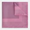 View 1 of product The Pink Dot Silk Pocket Square by Turnbull & Asser features pink silk with a border of small black dots, expertly handcrafted for a stylish touch to any suit. Fold to showcase both sides for added elegance.