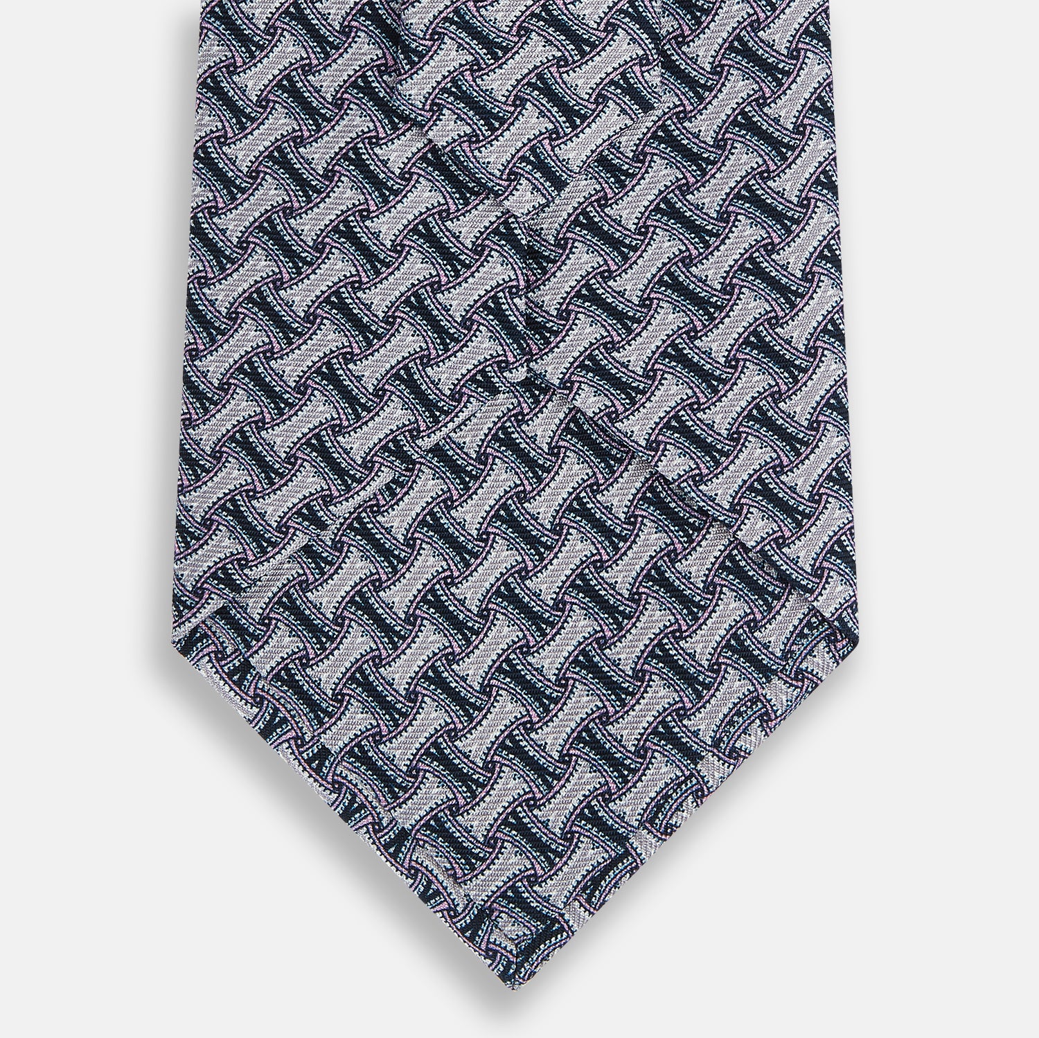 View 3 of product The Turnbull & Asser Navy and Pink Weave-Patterned Printed Silk Tie is shown rolled up on a white background, featuring a stylish geometric design.