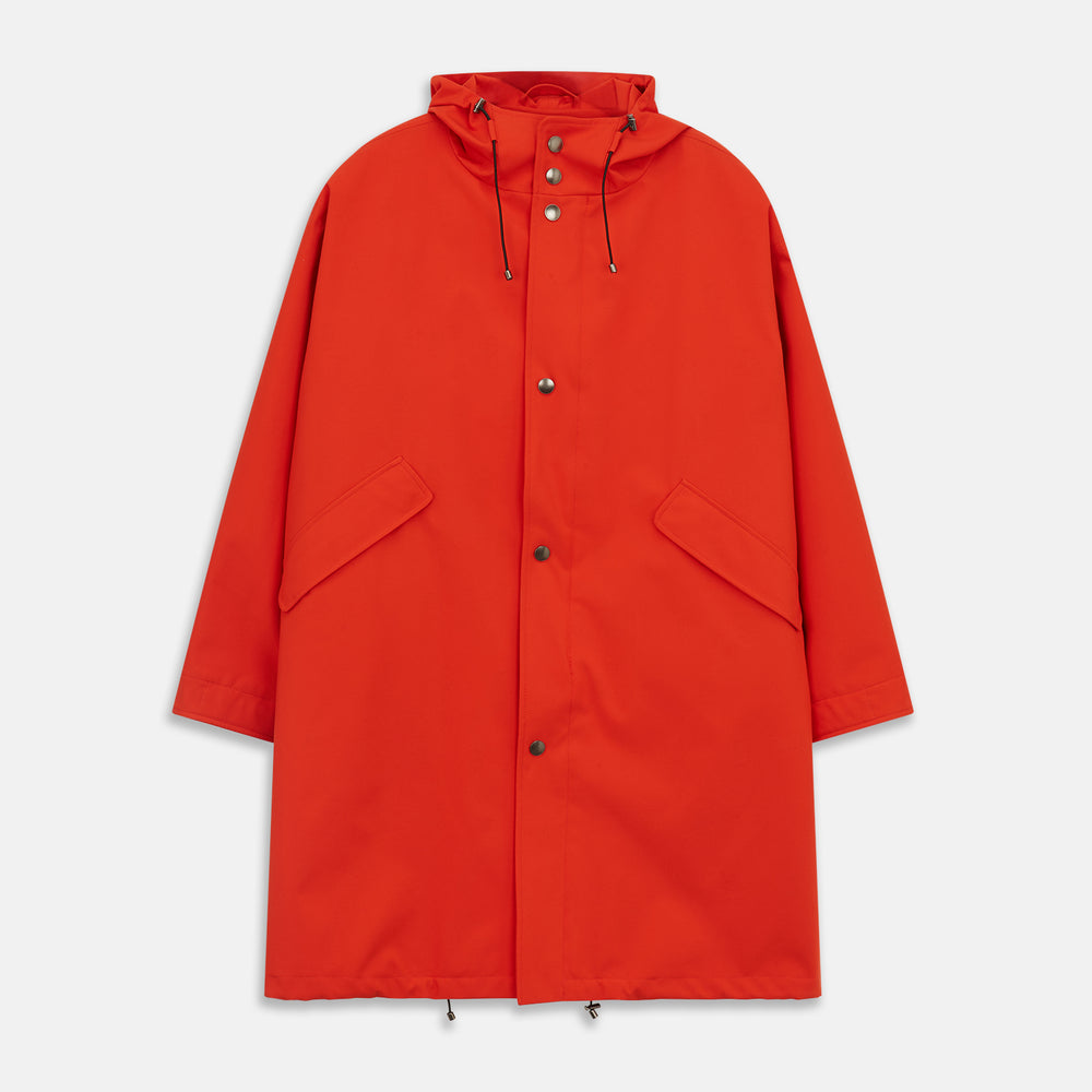 Wearing the Turnbull & Asser Red Walter Sealup Parka with Detachable Liner, black pants, and white sneakers, a person stands in profile against a plain light background—perfect for travel.