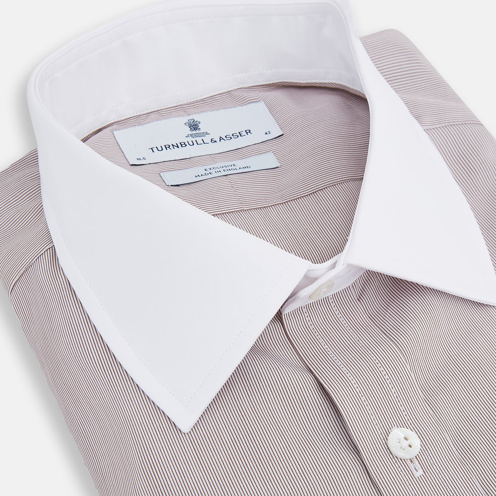 A Turnbull & Asser Burgundy Hairline Stripe Shirt with a contrast white collar and double cuffs, showcasing a tailored fit and button-down front, displayed against a plain white background.