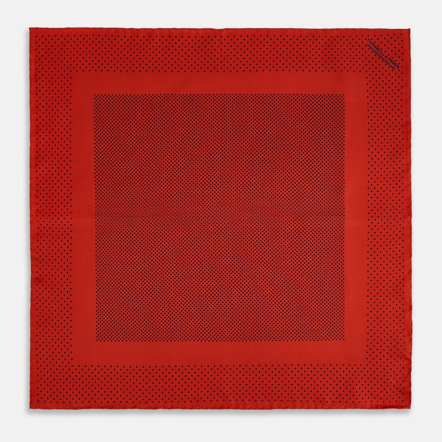 View 4 of product The Turnbull & Asser Red Dot Silk Pocket Square showcases small black dots on red silk, neatly folded to reveal both the front and part of the reverse side.