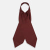 View 2 of product The Great Gatsby Burgundy Printed Silk Cravat by Turnbull & Asser features a maroon silk fabric with a small yellow and blue geometric pattern, subtle sheen, and neatly finished edges for an elegant, Gatsby-inspired formal accessory.