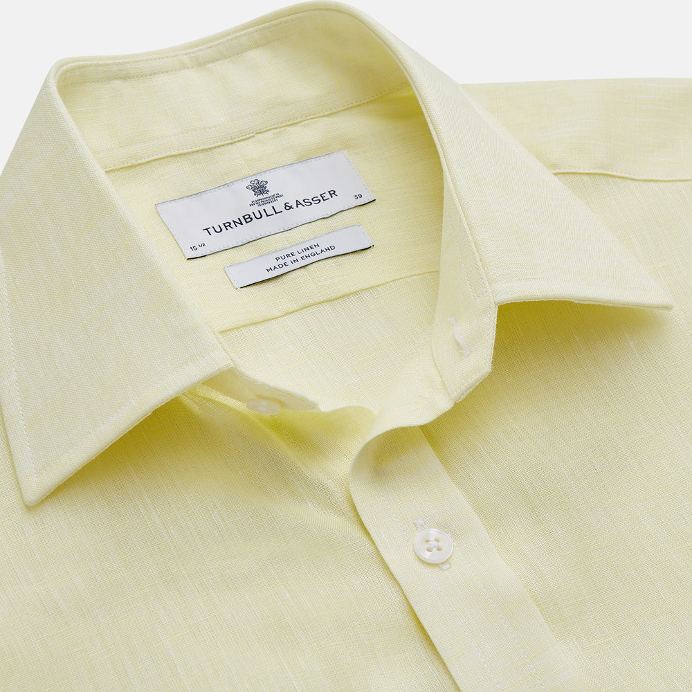 The Turnbull & Asser Yellow Linen Regular Fit Mayfair Shirt is a long-sleeve button-up with a collar and buttoned cuffs, shown laid flat on a white background.