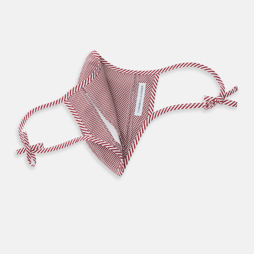The Turnbull & Asser Burgundy Check Commuter Mask comes with 3 Viroformula™ filters. It features a check pattern, adjustable ear straps, and is displayed on a plain white background.