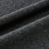 View 3 of product The Turnbull & Asser Plain Graphite Cashmere Knitted Scarf, draped and loosely knotted on a white background, showcases the refined elegance and timeless style of a luxury accessory.