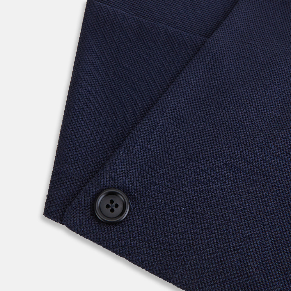 The Turnbull & Asser Navy Silk and Cotton Neck Warmer features a dark navy blue textured fabric and a single black button, shown against a plain light gray background.