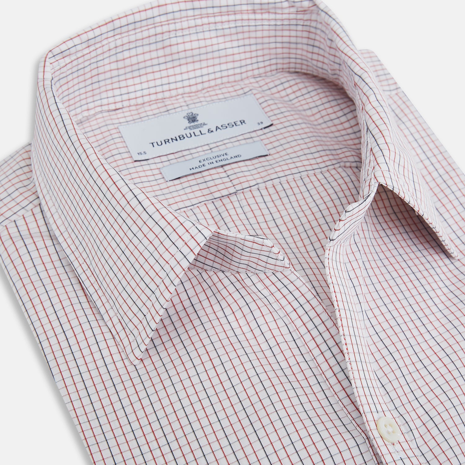 View 2 of product The Turnbull & Asser Red and Navy Check Windsor Shirt features a pointed collar and cuffed long sleeves, highlighting British craftsmanship. Displayed flat on a white background.
