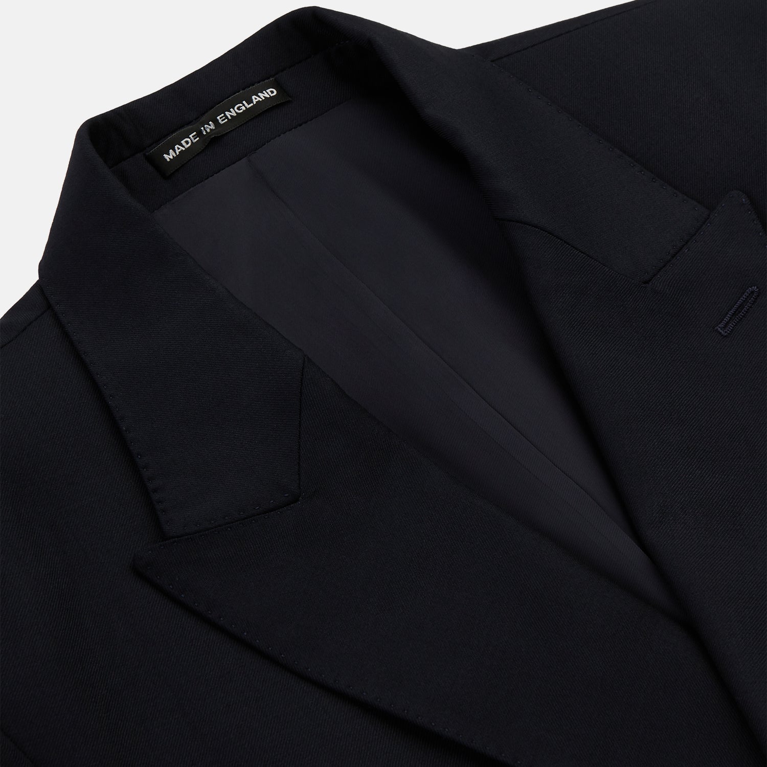 View 2 of product The Classic Navy Wool Blazer by Turnbull & Asser is a nautical double-breasted jacket with gold buttons, peaked lapels, three front pockets on one side, one on the other, and four gold buttons per cuff, shown against a white background.