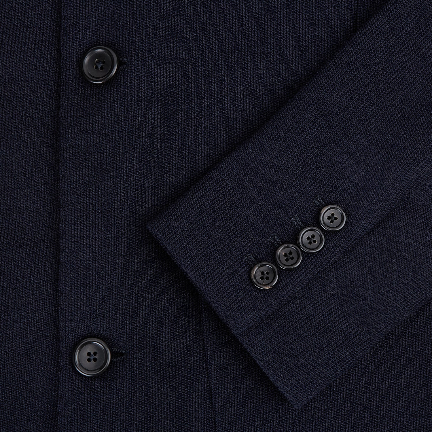 Image 4 of product The Navy Knitted Oxford Blazer by Turnbull & Asser features notch lapels, two front buttons, a chest pocket, and two lower patch pockets, shown against a plain white background.