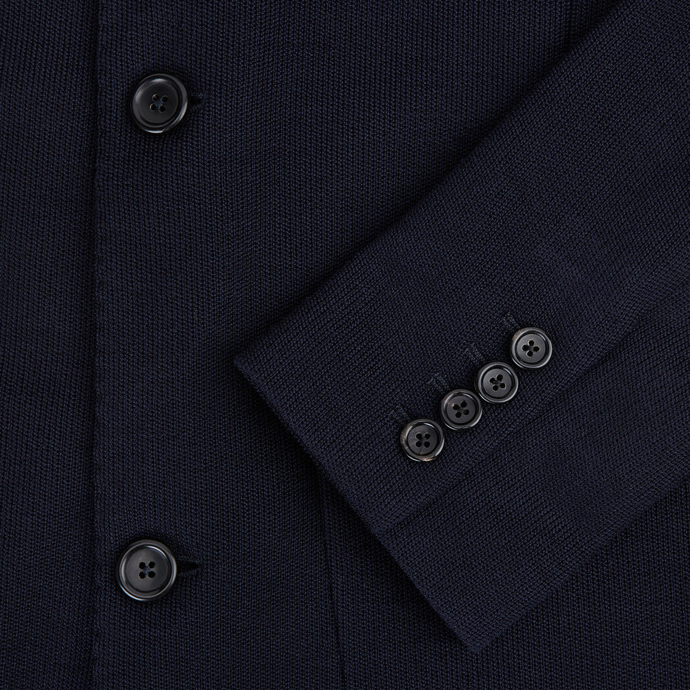 The Navy Knitted Oxford Blazer by Turnbull & Asser features notch lapels, two front buttons, a chest pocket, and two lower patch pockets, shown against a plain white background.