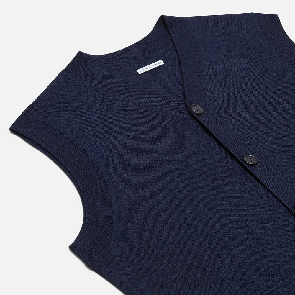 The Turnbull & Asser Navy Fine Merino V-Neck Sleeveless Cardigan features a front button closure, ribbed hem, and two pockets—sophisticated knitwear shown on a plain white background.