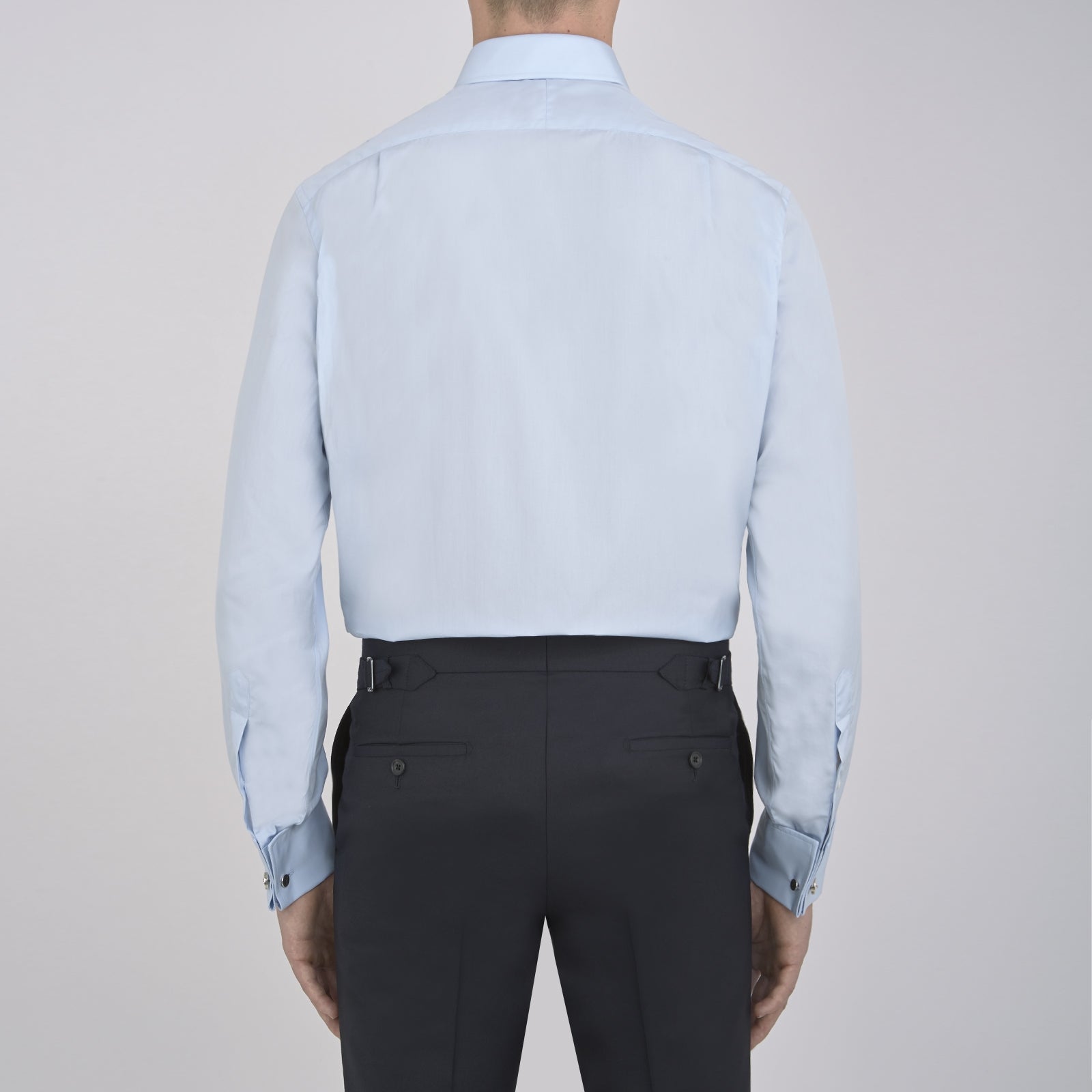 View 6 of product The Turnbull & Asser Light Blue Sea Island Quality Cotton Shirt features a T&A collar, double cuffs, white buttons, and a quality label inside the collar. Displayed on a plain white background.