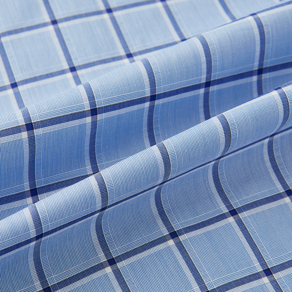 The Turnbull & Asser Blue and Navy Windowpane Mayfair Shirt features long sleeves, a T&A collar, buttoned cuffs, and Italian cotton in a blue and navy windowpane pattern, shown on a plain white background.