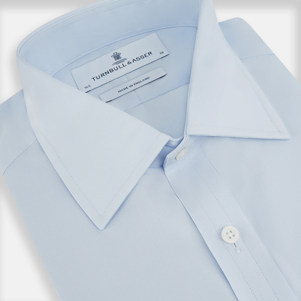 The Turnbull & Asser PALE BLUE COTTON REGULAR FIT MAYFAIR SHIRT is a long-sleeve, button-down shirt with a pointed T&A collar, shown laid flat on a white background.