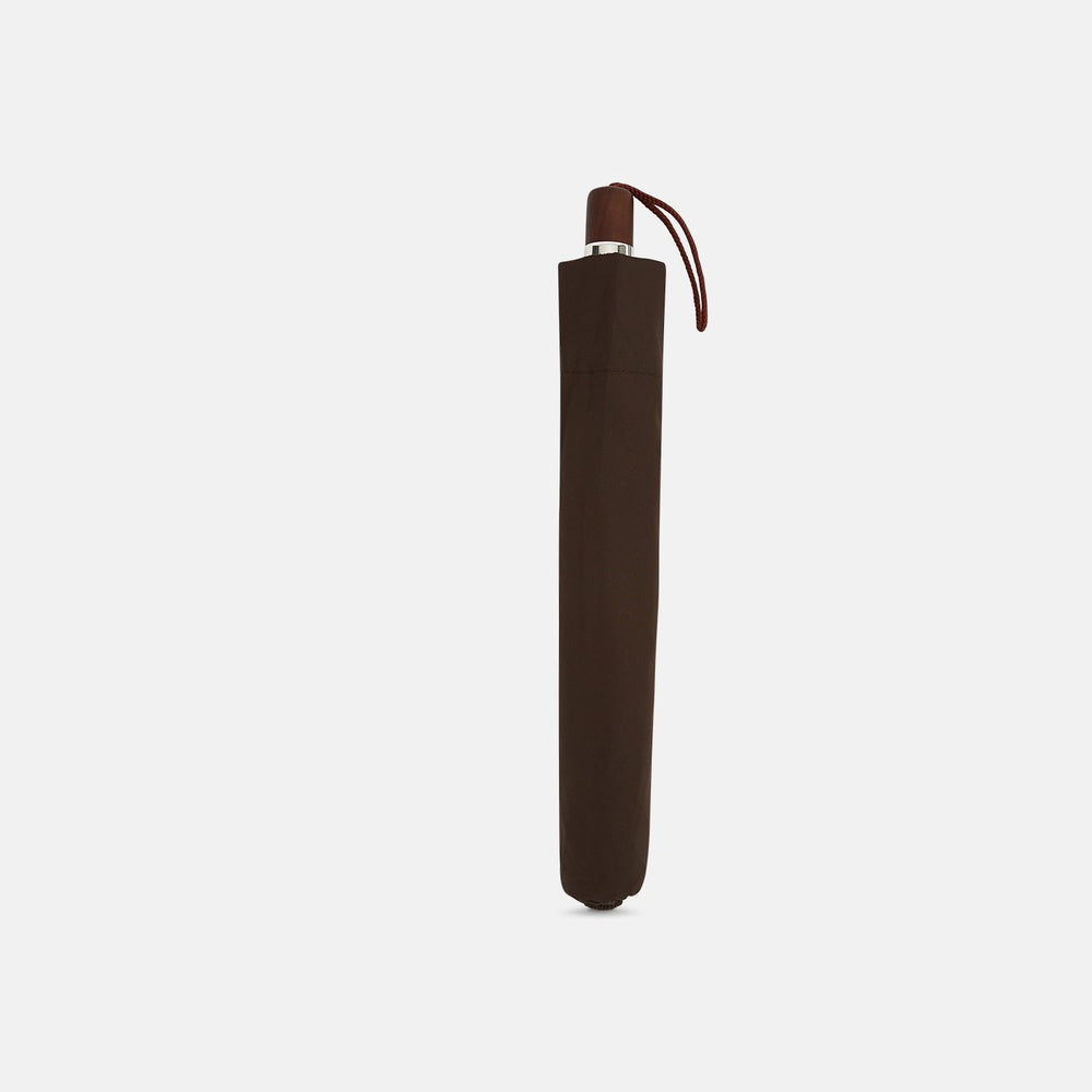 The Turnbull & Asser Brown Telescopic Umbrella features a brown maple handle and silver metal shaft—an elegant choice for men.