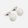 View 1 of product Turnbull & Asser’s Silver Striped Circle Cufflinks feature classic diagonal grooves and are shown against a white background.